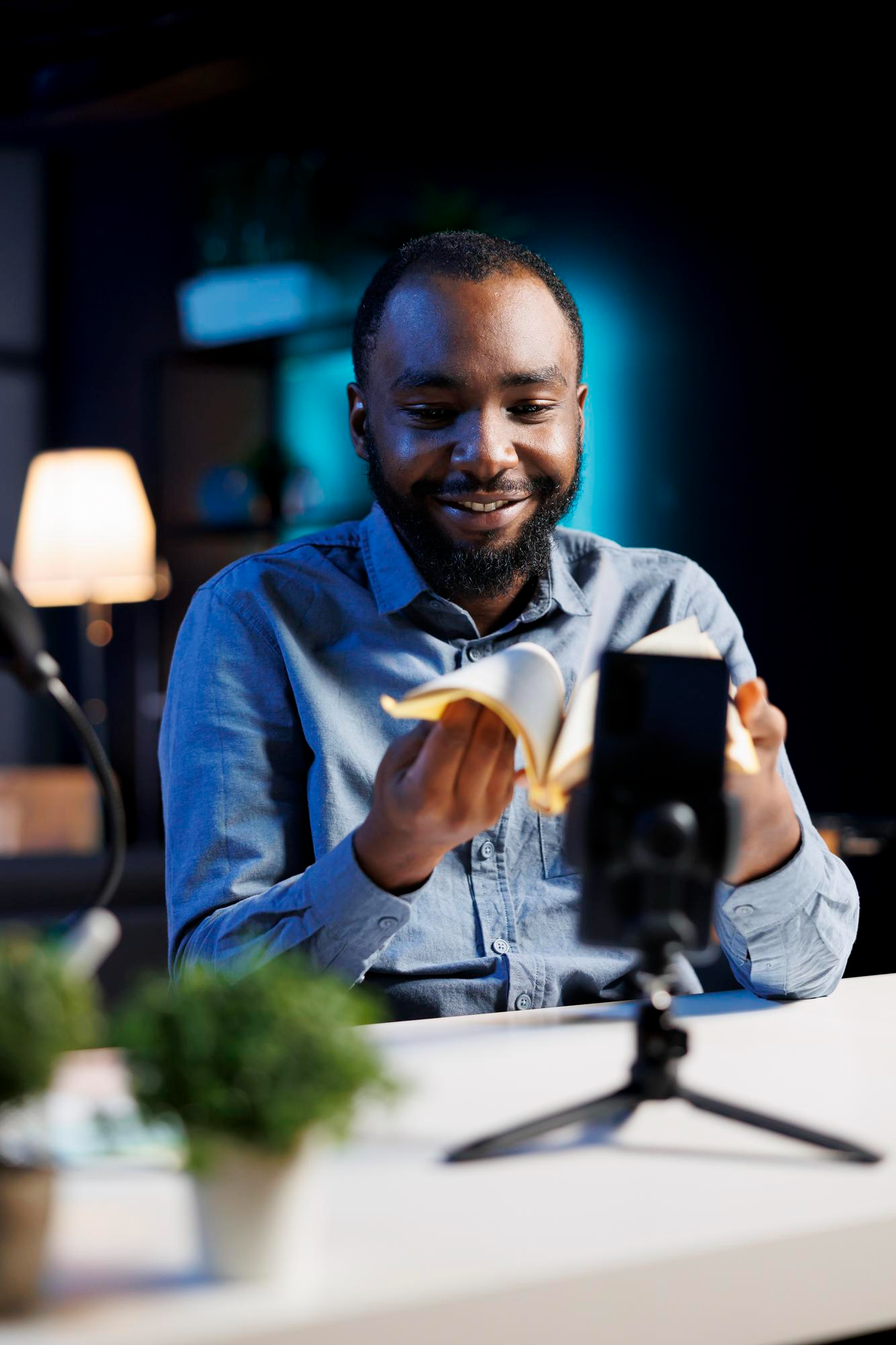 Creator sitting with book and phone